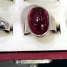 Men's ring with a smooth oval red aqeeq style stone in a plain polished band