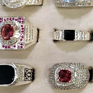 Men's ring with a square red stone surrounded by small clear and pink stones
