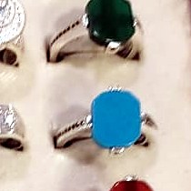 Men's ring with a bright turquoise blue cushion cut stone